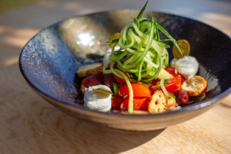 Greek salad with cherry tomatoes served with Galotyri cheese & crispy sesame breadsticks
