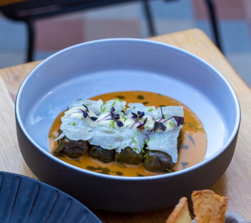Lahanodolmas with rich egg-lemon cream, charred cabbage, crispy kale chips and dill oil